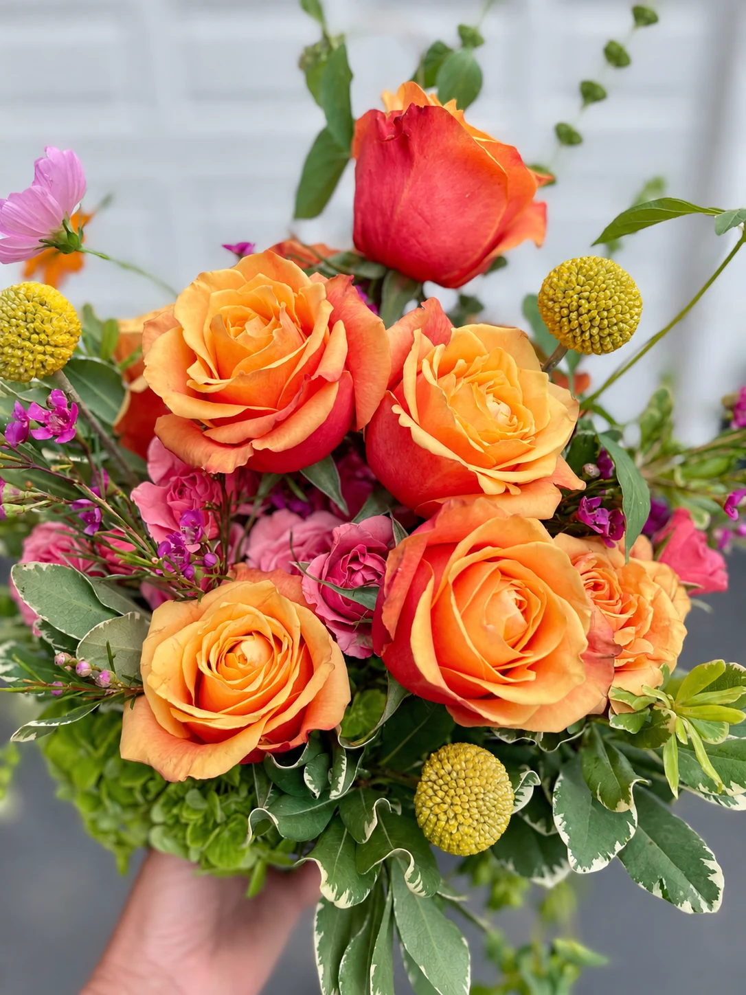 Golden and coral roses with fresh greenery